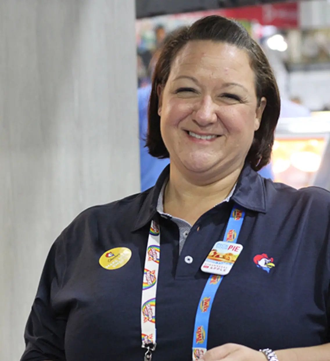 Person wearing a branded polo shirt.